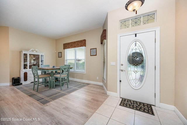 entrance foyer with light wood finished floors and baseboards