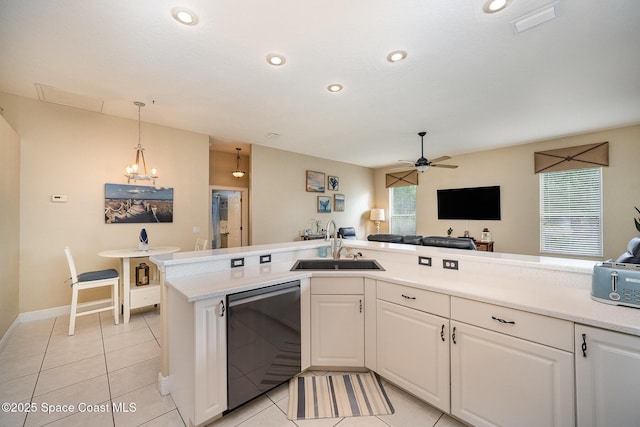 kitchen featuring visible vents, dishwasher, a sink, and white cabinetry