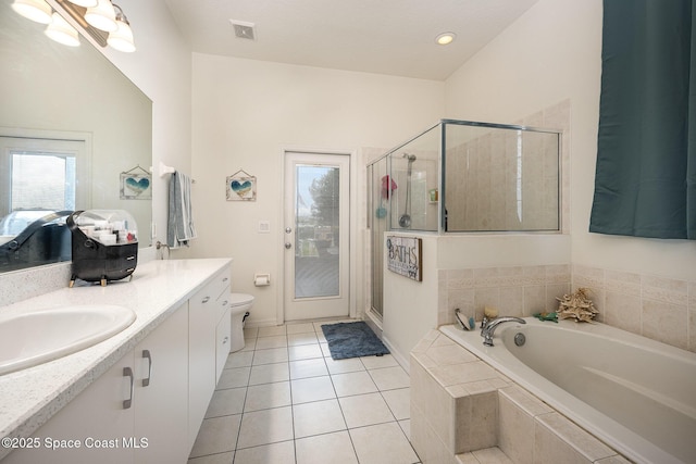 bathroom featuring tile patterned flooring, vanity, visible vents, a bath, and a stall shower