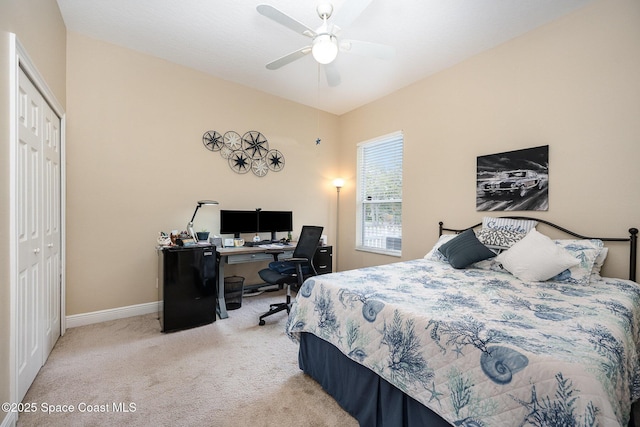 carpeted bedroom with ceiling fan, a closet, vaulted ceiling, and baseboards