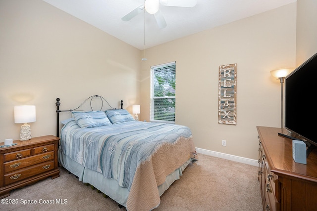 bedroom with lofted ceiling, light colored carpet, ceiling fan, and baseboards