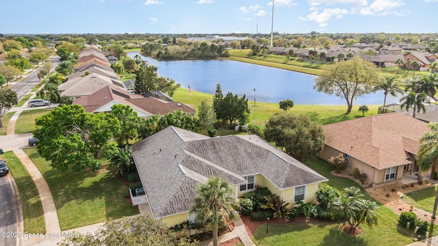 drone / aerial view featuring a water view and a residential view