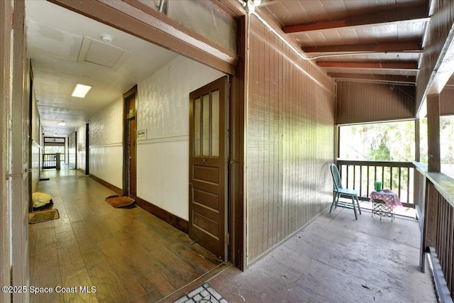 16 S St, Rockledge, FL 32955 - hallway featuring wood-type flooring, wainscoting, and vaulted ceiling with beams