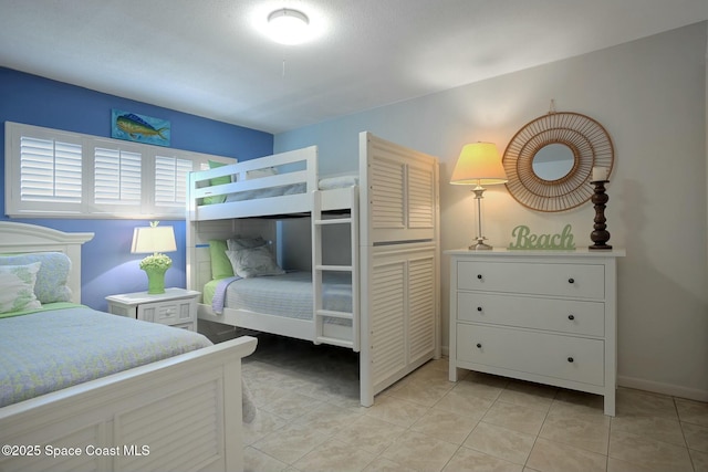 bedroom featuring light tile patterned floors