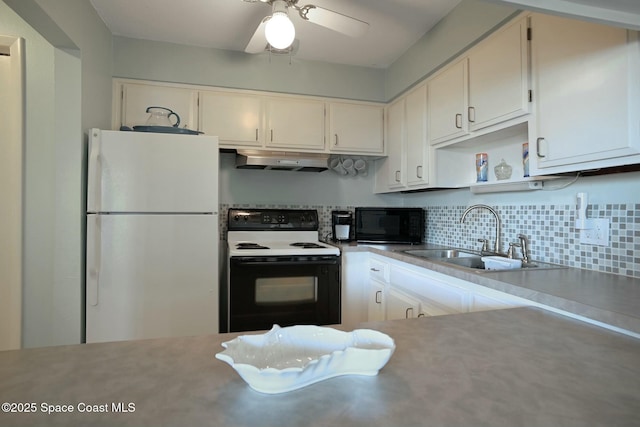 kitchen with black microwave, under cabinet range hood, freestanding refrigerator, electric range, and a sink