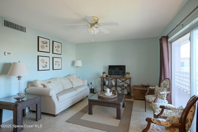 living room with light tile patterned floors, a ceiling fan, and visible vents