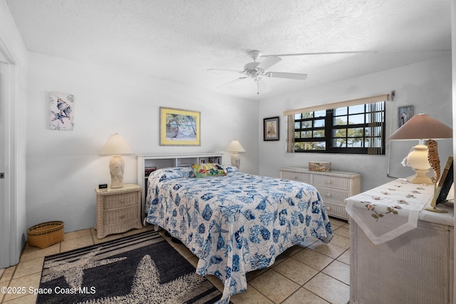 tiled bedroom with a textured ceiling and a ceiling fan