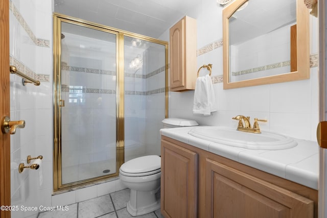 bathroom featuring vanity, a shower stall, toilet, and tasteful backsplash