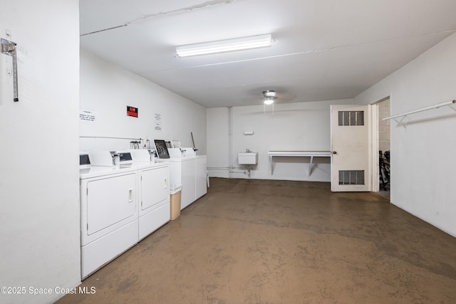 shared laundry area featuring a sink, visible vents, and washer and clothes dryer