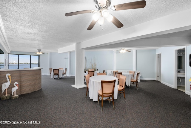 dining area featuring baseboards, dark colored carpet, and a textured ceiling