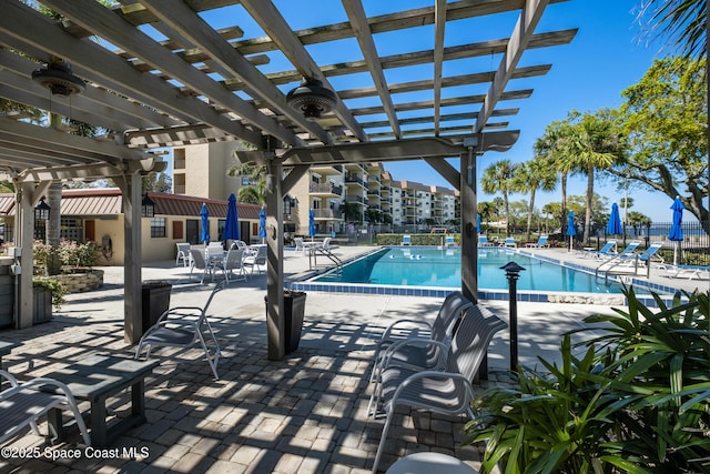 pool featuring a pergola, a patio, and fence