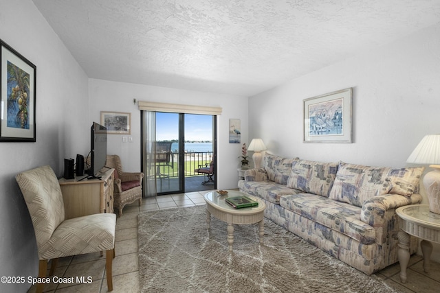 living area with tile patterned floors and a textured ceiling