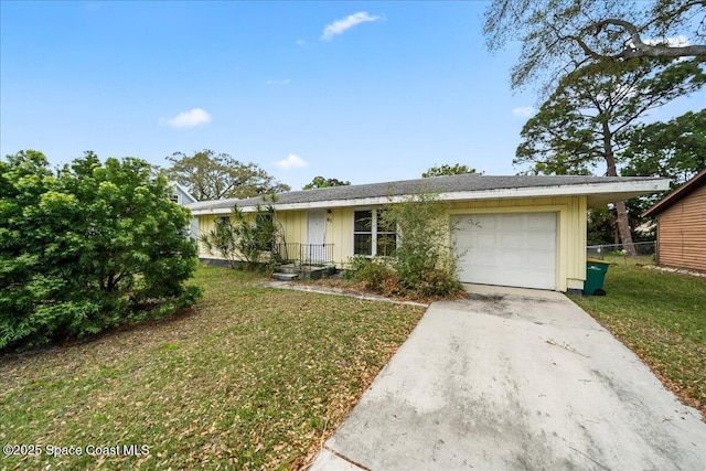 ranch-style home with driveway, an attached garage, fence, a front lawn, and board and batten siding