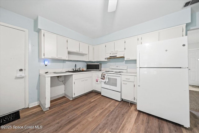 kitchen with white appliances, visible vents, white cabinets, under cabinet range hood, and a sink