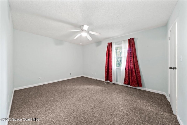 carpeted empty room featuring ceiling fan, a textured ceiling, and baseboards