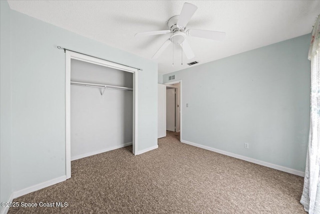 unfurnished bedroom featuring carpet, a closet, visible vents, and baseboards