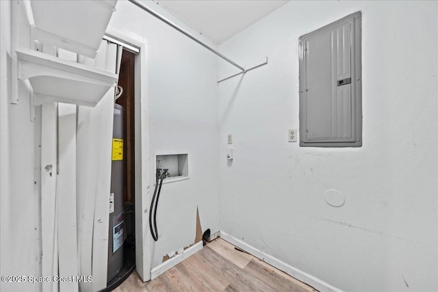 clothes washing area featuring laundry area, light wood finished floors, electric panel, baseboards, and washer hookup