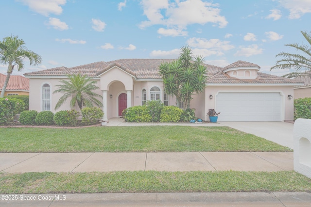 mediterranean / spanish-style house featuring a front yard, driveway, stucco siding, a garage, and a tiled roof