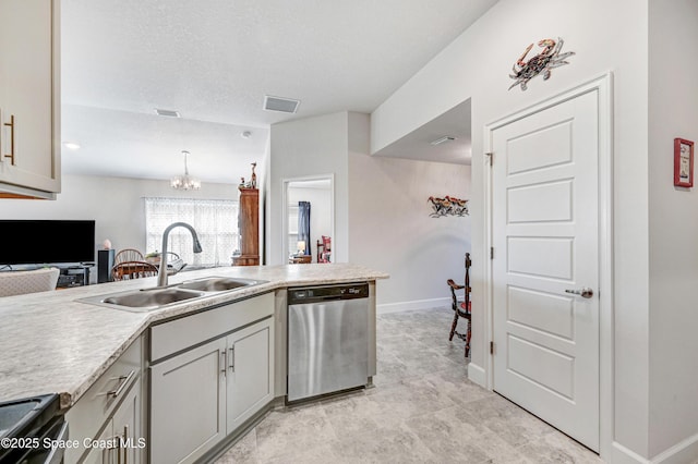 kitchen featuring visible vents, appliances with stainless steel finishes, gray cabinets, light countertops, and a sink