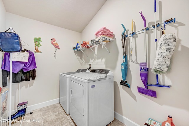 laundry area with light tile patterned floors, laundry area, separate washer and dryer, and baseboards