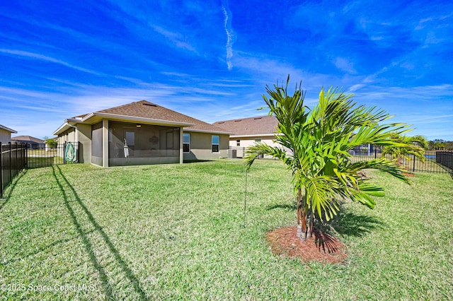 view of yard with a fenced backyard and a sunroom