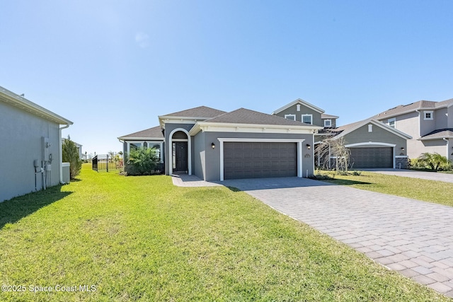 view of front of house featuring central AC unit, a garage, decorative driveway, stucco siding, and a front lawn