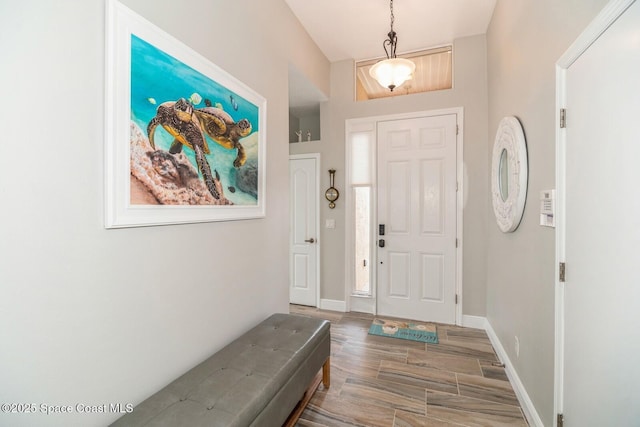 entrance foyer featuring wood finished floors and baseboards