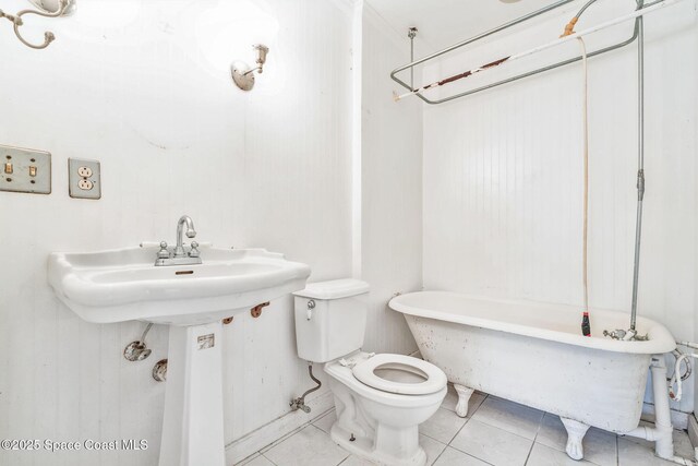 bathroom with a bathtub, tile patterned flooring, and toilet