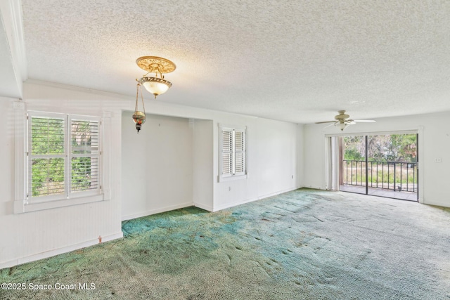 unfurnished room featuring a textured ceiling, ceiling fan, and carpet