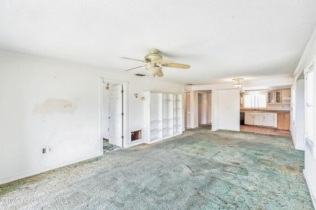 unfurnished living room featuring baseboards, visible vents, light colored carpet, ceiling fan, and a textured ceiling