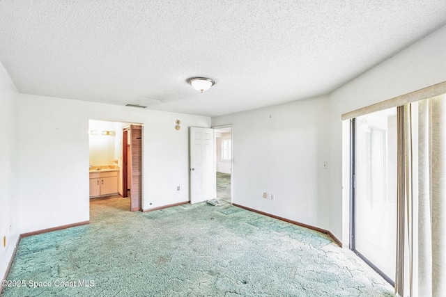 unfurnished bedroom featuring baseboards, a textured ceiling, visible vents, and carpet flooring