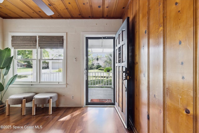 entryway with wood finished floors, wood ceiling, and baseboards