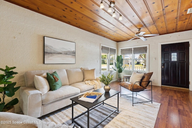 living area with visible vents, a textured wall, wood ceiling, ceiling fan, and wood finished floors