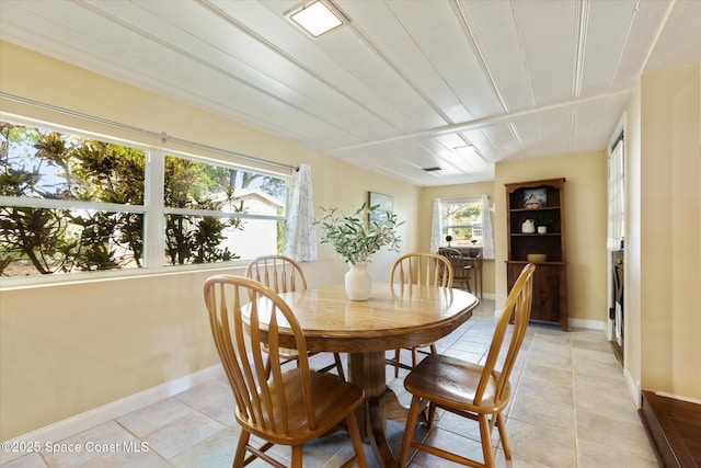 dining room with light tile patterned flooring and baseboards