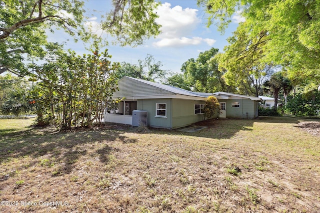 back of property featuring a yard