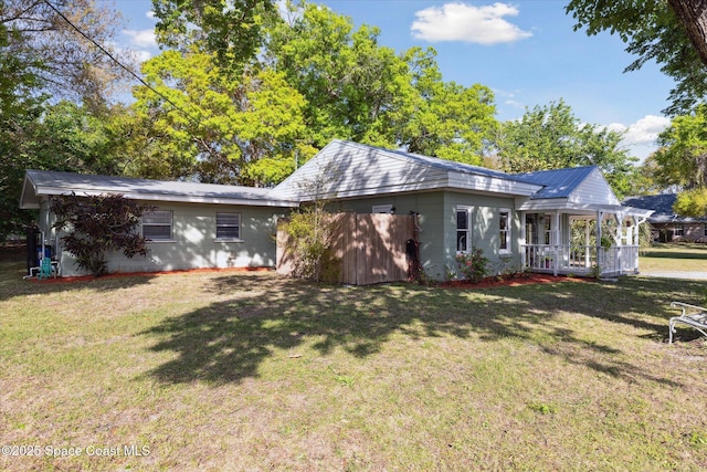 view of front of house with a front yard and concrete block siding