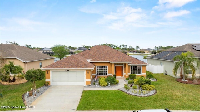 single story home featuring a garage, driveway, fence, a front lawn, and stucco siding