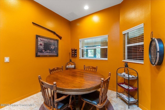 dining space with light tile patterned floors, baseboards, and recessed lighting