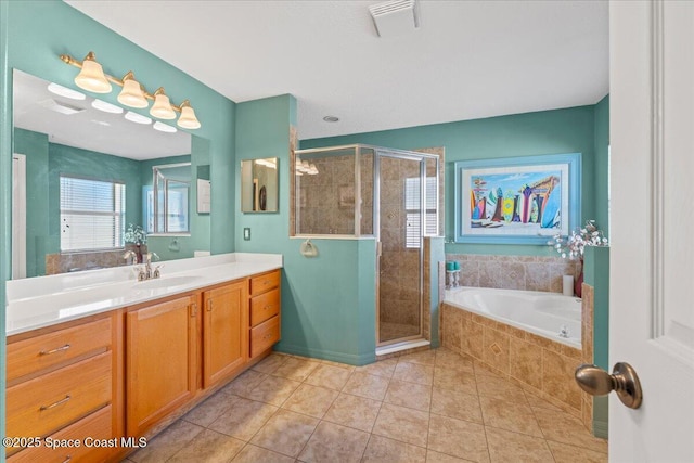 full bathroom with a stall shower, a garden tub, vanity, and tile patterned floors