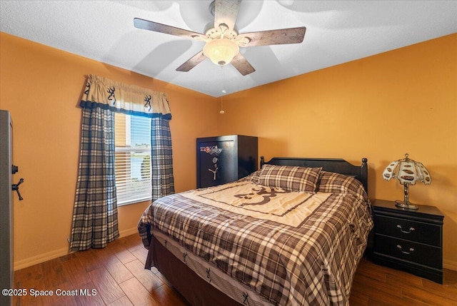 bedroom with wood finished floors, a ceiling fan, and baseboards