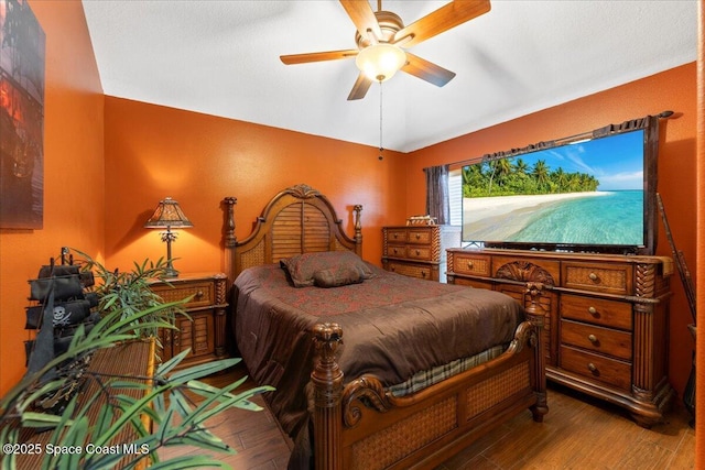 bedroom featuring a ceiling fan and wood finished floors