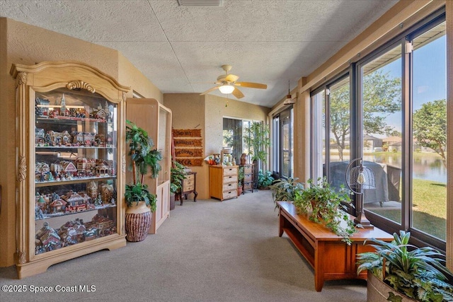 sunroom with ceiling fan