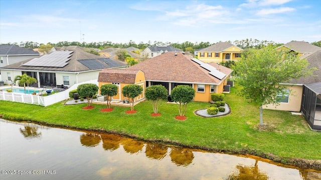 birds eye view of property with a water view and a residential view