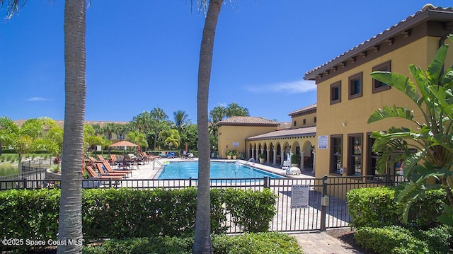 pool featuring a patio area and fence