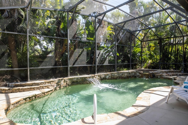 view of pool featuring a lanai, a patio, and a hot tub