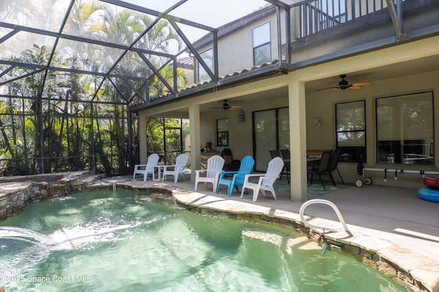 pool with a ceiling fan, glass enclosure, and a patio