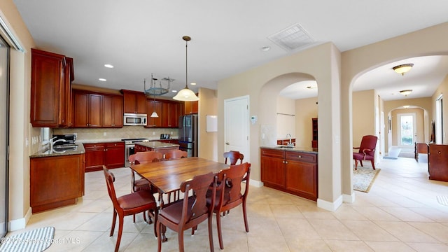 dining room with light tile patterned floors, baseboards, visible vents, and recessed lighting