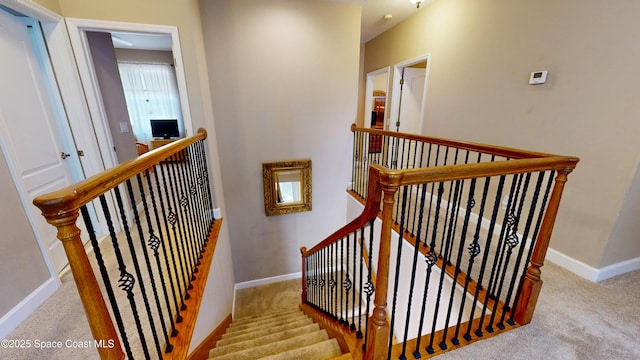 stairs featuring baseboards and carpet flooring