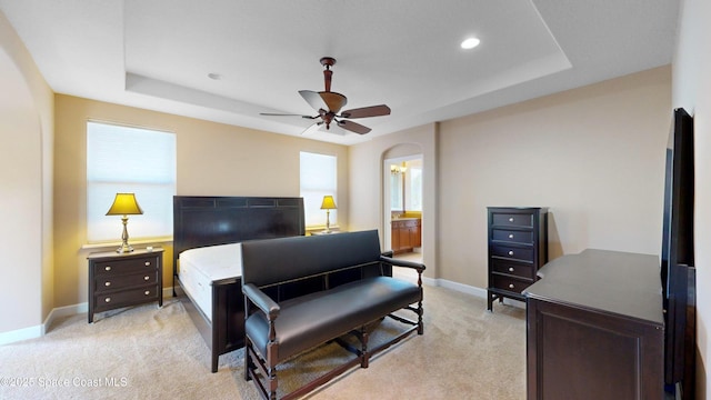 bedroom featuring a tray ceiling, light carpet, baseboards, and recessed lighting