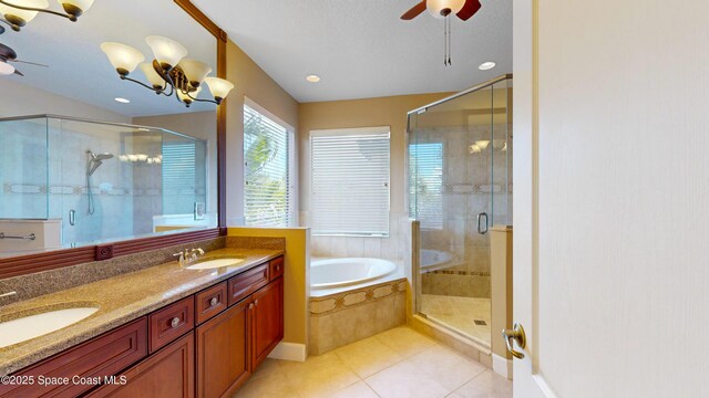 full bath featuring a garden tub, a shower stall, tile patterned flooring, and a sink